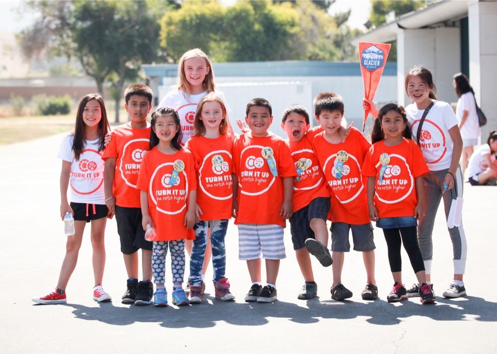Elementary school fundraiser — kids in matching bright orange shirts